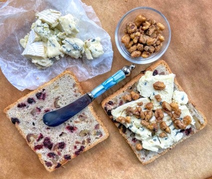 Grilled cheese sandwich being constructed from Tuscan Coffeecake, Cambozola cheese, and candied walnuts.